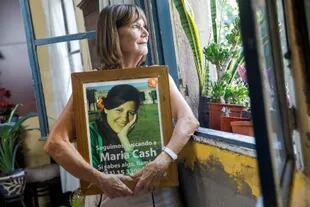 Maria del Carmen Gallego, en su hogar, con el retrato de su hija en sus brazos