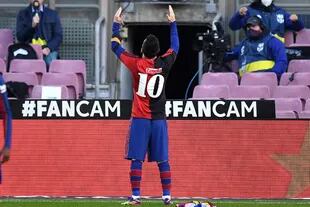 BARCELONA, SPAIN - NOVEMBER 29: Lionel Messi of Barcelona celebrates after scoring their sides fourth goal while wearing a Newell's Old Boys shirt with the number 10 on the back in memory of former footballer, Diego Maradona, who recently passed away during the La Liga Santander match between FC Barcelona and C.A. Osasuna at Camp Nou on November 29, 2020 in Barcelona, Spain. Sporting stadiums around Spain remain under strict restrictions due to the Coronavirus Pandemic as Government social distancing laws prohibit fans inside venues resulting in games being played behind closed doors. (Photo by David Ramos/Getty Images)
