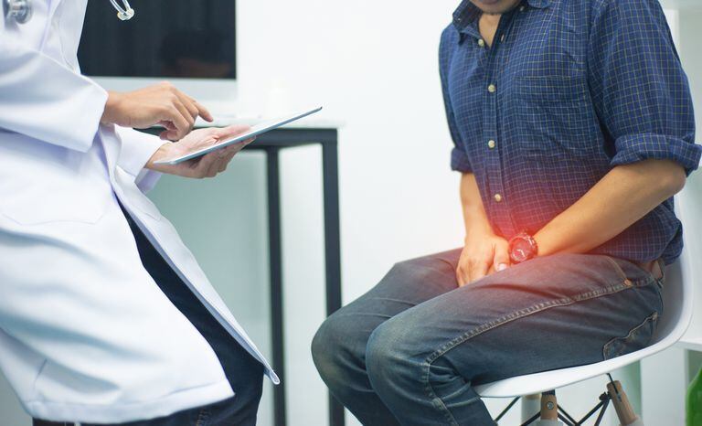 Male health concepts. The young man with pain consulted a doctor for treatment. The doctor is interviewing and advising the patients.