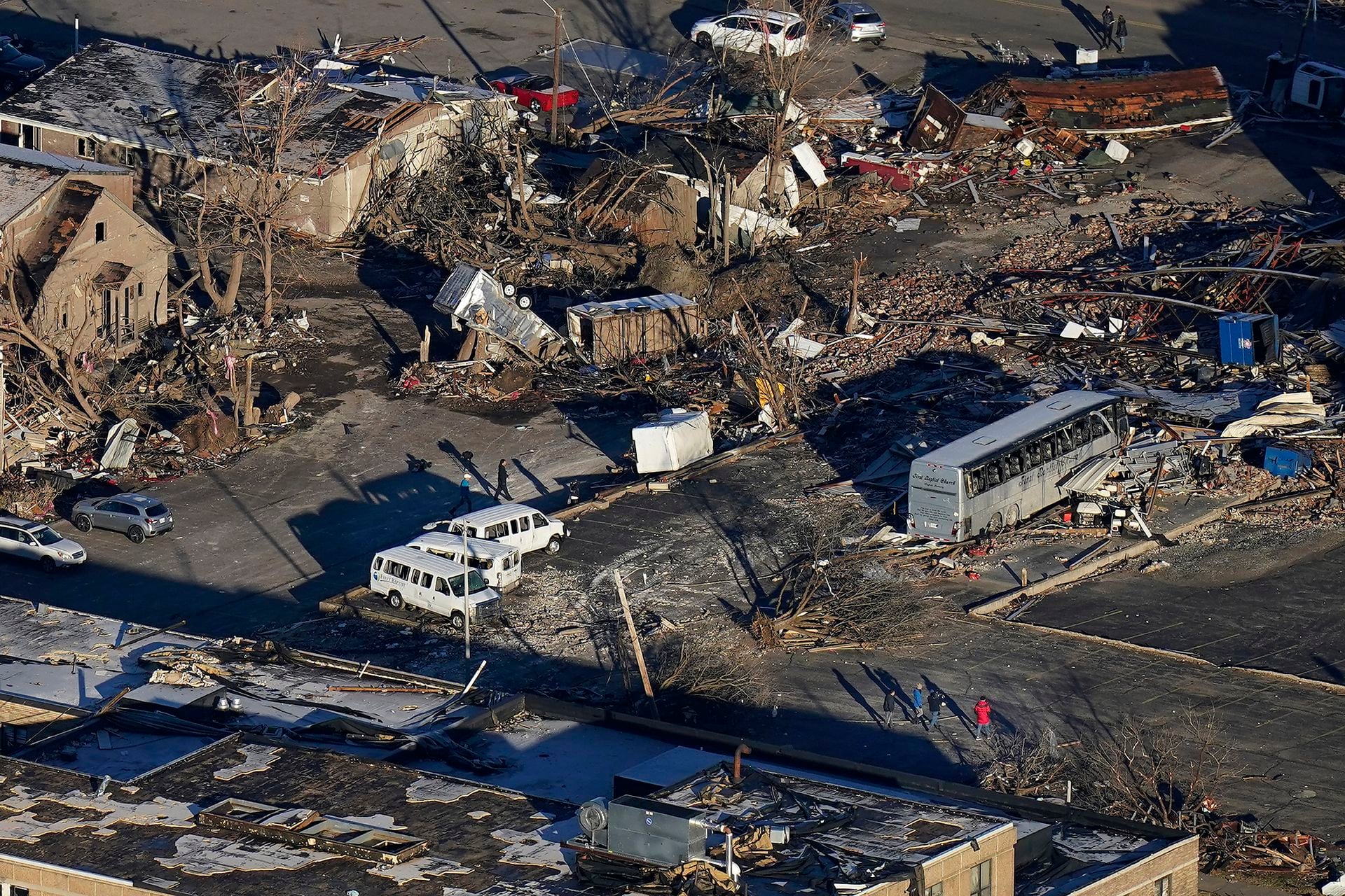 Ky, people walking amid the devastation of the recent hurricane in Mayfield Downtown