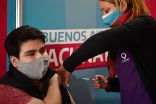 Una trabajadora de salud aplica la vacuna de Moderna contra COVID-19 a un joven en un centro de salud en Quilmes, Argentina