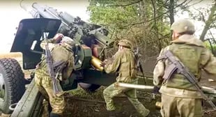 In this photo released by the Russian Defense Ministry's press service on Saturday, September 10, 2022, Russian soldiers prepare to fire a 152.4mm Msta-B howitzer from their position at an undisclosed location in Ukraine. 