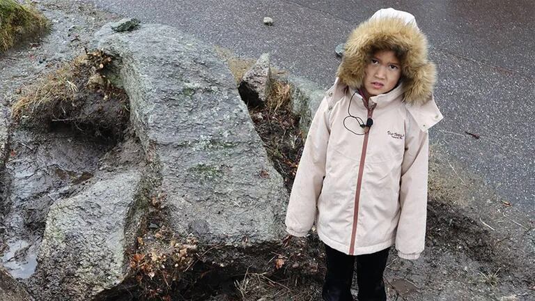 He is eight years old, and while playing in the schoolyard, he finds an ancient stone that has baffled archaeologists