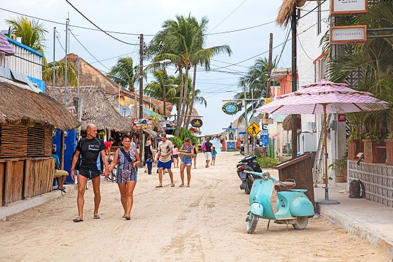Western tourists walking in street on Isla Holbox, island in the Mexican state of Quintana Roo, along the north coast of the Yucat‡n Peninsula, Mexico. (Photo by: Marica van der Meer/Arterra/Universal Images Group via Getty Images)