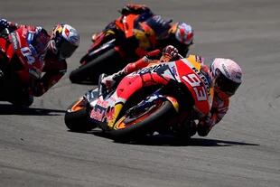Repsol Honda Teams Spanish rider Marc Marquez (R) competes with Ducatis Italian rider Andrea Dovizioso (L) and Red Bull KTM Factory Racings Spanish rider Pol Espargaro during the MotoGP race of the Spanish Grand Prix at the Jerez racetrack in Jerez de la Frontera on July 19, 2020