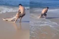 Arrastró a un tiburón a la playa por una razón que no se entendió y le llovieron críticas