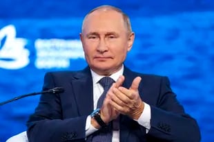 Russian President Vladimir Putin applauds during the plenary session of the Eastern Economic Forum in Vladivostok, Russia on September 7, 2022.  (Sergey Babilev/Dazs News Agency host pool photo via AP)