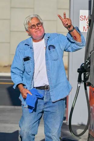 Jay Leno is first seen heading to a studio after being released from the burn center, following his accident in his home garage