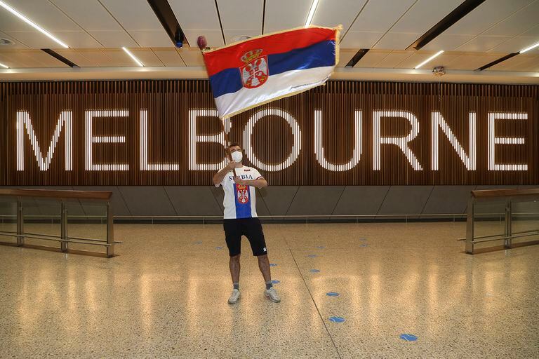 Una imagen simbólica: un solitario fan de Djokovic, bandera en mano, lo esperaba en el salón de arribos del aeropuerto de Melbourne 