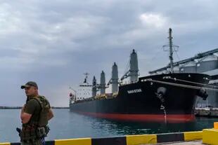 FILE - A security guard looks over the stranded Navi-Star ship from Russia's invasion of Ukraine as it waits for permission to depart the port of Odessa, Ukraine, July 29, 2022.  (AP Photo/David Goldman)