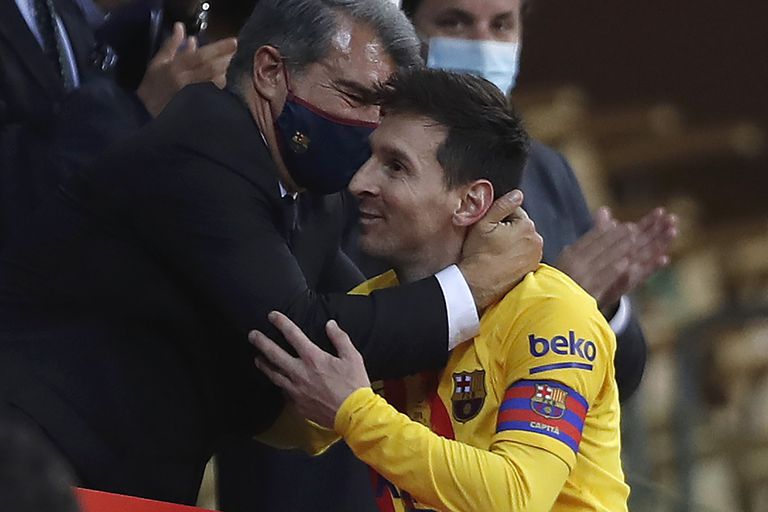 Barcelona's Lionel Messi with Barcelona president Joan Laporta after winning the Spanish Copa del Rey final 2021 against Athletic Bilbao at La Cartuja stadium in Seville, Spain, Saturday April 17, 2021. (AP Photo/Angel Fernandez)
