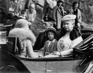 Aged six, on 1 September 1932 while staying at Balmoral, traveling in a carriage with her grandparents, King George V and Mary, after visiting church in Aberdeenshire.