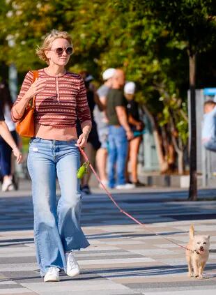 Naomi Watts goes for a walk with her dog in New York City.  The 53-year-old actress opted for a long-sleeved striped sweater paired with faded pants and white sneakers.
