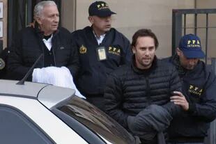Hugo, con las manos cubiertas, y Mariano al dejar los Tribunales de Comodoro Py para quedar detenidos