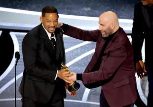 HOLLYWOOD, CALIFORNIA - MARCH 27: (L-R) Will Smith accepts the Actor in a Leading Role award for King Richard from John Travolta onstage during the 94th Annual Academy Awards at Dolby Theatre on March 27, 2022 in Hollywood, California.   Neilson Barnard/Getty Images/AFP
== FOR NEWSPAPERS, INTERNET, TELCOS & TELEVISION USE ONLY ==