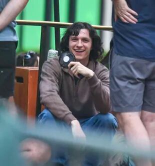 Tom Holland sports a seventies style and long hair for the new series he is working on 
