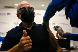 Emilio Estefan, 67, productor musical internacional, levanta el pulgar mientras recibe su primera dosis de la vacuna Pfizer-BioNtech contra la Covid-19 en el Centro de Rehabilitación Christine E. Lynn, en Miami, Florida, el 30 de diciembre de 2020