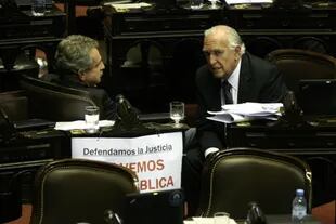 El jefe del bloque kirchnerista, Agustín Rossi, dialoga en la Cámara de Diputados con el radical Ricardo Gil Lavedra