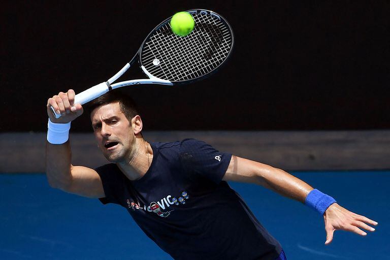 Novak Djokovic of Serbia hits a return during a practice session ahead of the Australian Open at the Melbourne Park tennis centre in Melbourne on January 12, 2022. (Photo by William WEST / AFP) / -- IMAGE RESTRICTED TO EDITORIAL USE - STRICTLY NO COMMERCIAL USE --