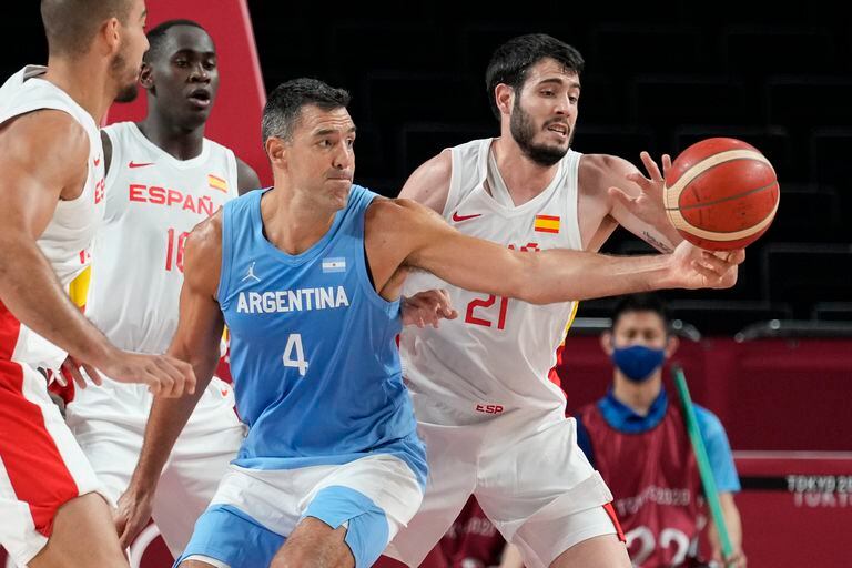 Spain's Alejandro Abrines Redondo (21) tries to steal the ball from Argentina's Luis Scola (4) during a men's basketball preliminary round game at the 2020 Summer Olympics, Thursday, July 29, 2021, in Saitama, Japan. (AP Photo/Eric Gay)