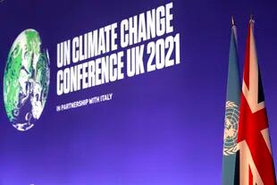 Las banderas de Gran Bretaña y Naciones Unidas se ven colocadas en la sala de conferencias antes de la inauguración de la cumbre climática de Naciones Unidas COP26 en Glasgow el domingo 31 de octubre de 2021. (AP Foto/Alberto Pezzali, Pool)