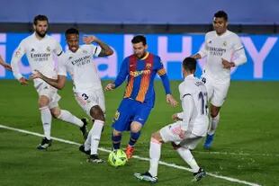 Lionel Messi domina la pelota entre jugadores del Madrid durante el clásico entre Real Madrid y Barcelona, que se juega en el estadio Alfredo Di Stéfano, de la capital española.