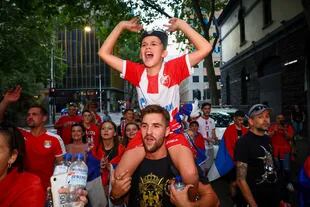 Los partidarios del serbio Novak Djokovic bailan y celebran frente a las oficinas de su equipo legal en Melbourne, tras la batalla judicial para anular la cancelación de su visa por motivos de salud de Covid.