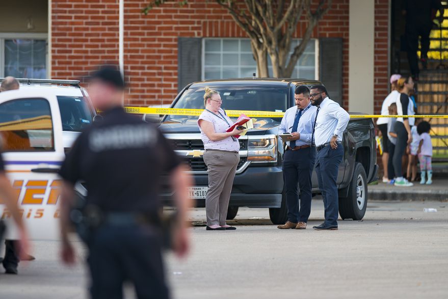 Police officers near the home where the skeletal remains of a minor were found in Houston, Texas