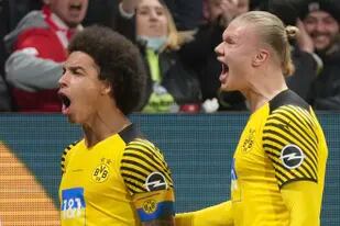 Axel Witsel (izquierda) del Borussia Dortmund celebra con Erling Haaland tras marcar el primer gol en ante Mainz en la Bundesliga, el miércoles 16 de marzo de 2022. (AP Foto/Michael Probst)