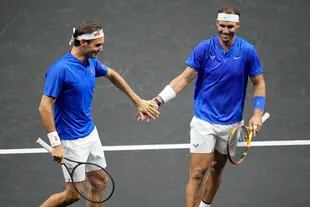 Team Europe's Roger Federer, left, and Rafael Nadal react during their Laver Cup doubles match against Team World's Jack Sock and Frances Tiafoe at the O2 arena in London, Friday, Sept. 23, 2022. (AP Photo/Kin Cheung)
