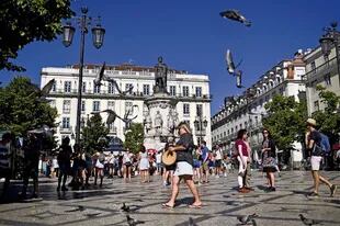 Miles de turistas llegan a diario a Lisboa y pasean por la Plaza Camoes