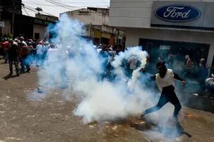 Un manifestante recoge un bote de gas lacrimógeno durante enfrentamientos con las fuerzas de seguridad en una manifestación contra el gobierno de Nicolás Maduro, en San Antonio del Táchira, Venezuela.