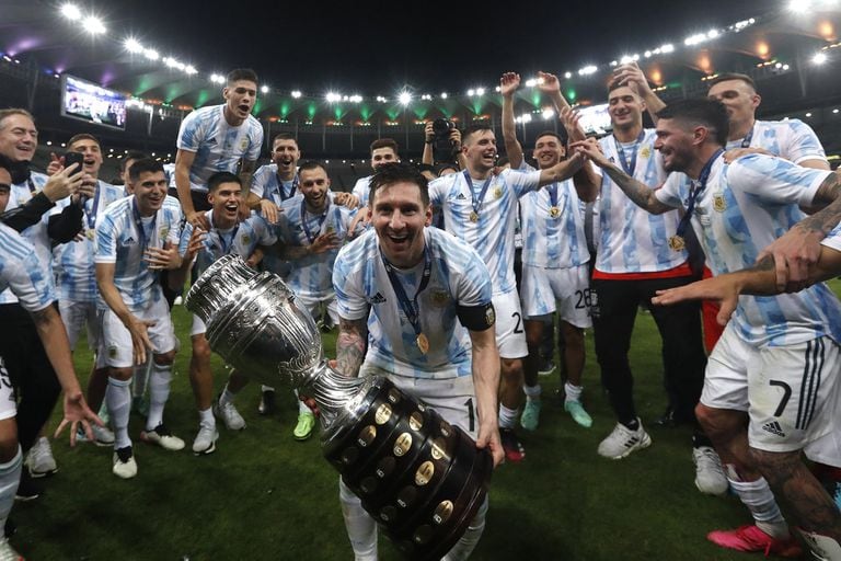 Argentina's Lionel Messi celebrates with the trophy after beating Brazil 1-0 in the Copa America final soccer match at the Maracana stadium in Rio de Janeiro, Brazil, Saturday, July 10, 2021. (AP Photo/Bruna Prado