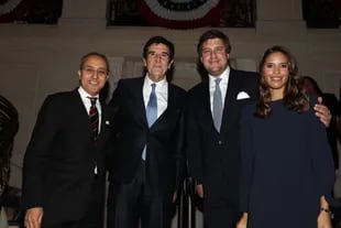Carlos Melconian with party guests