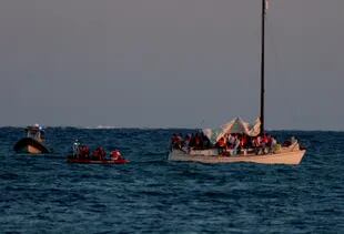 US Customs and Border Protection, along with local law enforcement and other agencies, attend to a sailboat with more than two dozen Haitian immigrants on board near Virginia Key on January 12, 2023 in Miami Florida.