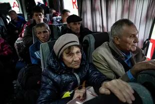 Personas sentadas en un autobús durante una evacuación en Lyman, en la región de Donetsk, en el este de Ucrania, el sábado 30 de abril de 2022. (Foto AP/Evgeniy Maloletka)