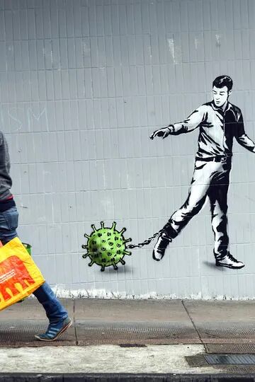 Un mural pintado que muestra a un hombre atrapado por el coronavirus, Glasgow, Inglaterra