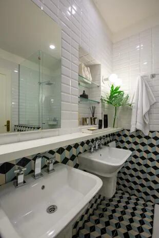 El baño de los chicos mezcla azulejos esmaltados con calcáreos diseñados por la arquitecta María Zunino y tiene bachas separadas.