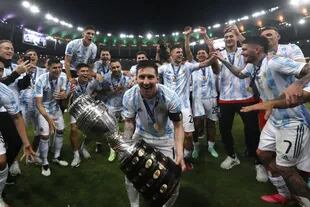 Argentina's Lionel Messi celebrates with the trophy after beating Brazil 1-0  in the Copa America final soccer match at the Maracana stadium in Rio de Janeiro, Brazil, Saturday, July 10, 2021. (AP Photo/Bruna Prado