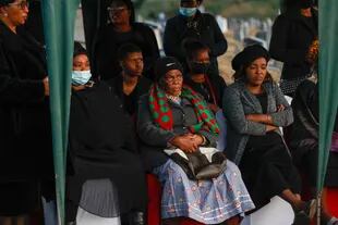 Relatives of Thembingosi Silvane watch his burial at Heaven Hills Cemetery in East Londos on July 6, 2022, after 20 people, mostly teenagers, died in unclear circumstances at a township restaurant last month.  , an incident that shocked South Africa.  (Photo by Bill Makako/AFP)