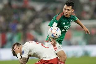 Mexico's Hirving Lozano, right, and Poland's Nicola Zalewski battle for the ball during the World Cup group C soccer match between Mexico and Poland, at the Stadium 974 in Doha, Qatar, Tuesday, Nov. 22, 2022. (AP Photo/Moises Castillo)