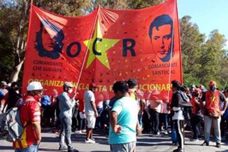 Columnas de la Organización Clasista Revolucionaria, con pecheras y banderas reivindicativas de El Che y Santucho