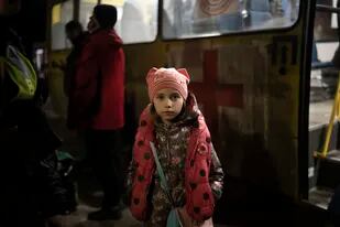Una niña ucraniana desplazada dentro del país espera a sus familiares fuera de un bus a su llegada a Zaporiyia, Ucrania, el 1 de abril de 2022. (AP Foto/Felipe Dana)