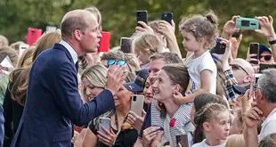 Prince William meets people after viewing the floral tributes for the late Queen Elizabeth II outside Windsor Castle, in Windsor, England, Saturday, Sept. 10, 2022. (AP Photo/Martin Meissner)