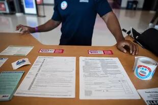 Un trabajador se encuentra en una cabina de registro socialmente distanciada en Rocket Mortgage Fieldhouse, donde se llevó a cabo un evento de registro de votantes el 21 de septiembre de 2020 en Cleveland, Ohio