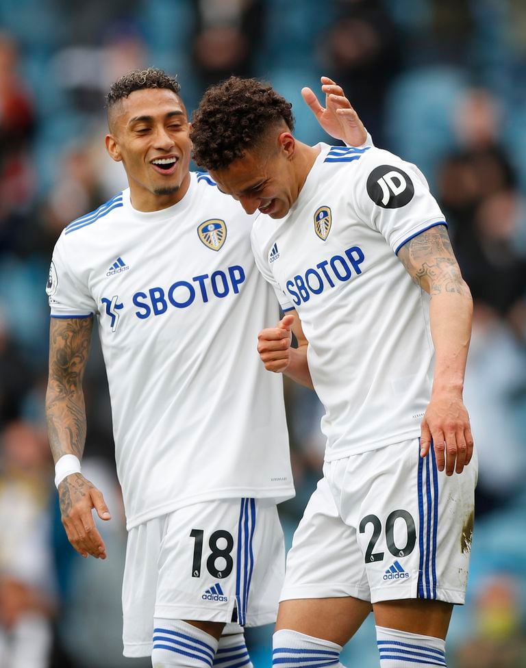 Leeds United's Rodrigo, right, celebrates scoring the opening goal during the English Premier League soccer match between Leeds United and West Brom at Elland Road in Leeds, England, Sunday May 23, 2021. (Lynne Cameron/Pool via AP)