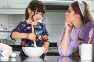Tea time games.  Mother and daughter make vanilla pudding.