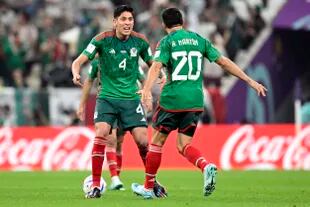 Mexico's forward #20 Henry Martin (R) celebrates scoring his team's first goal during the Qatar 2022 World Cup Group C football match between Saudi Arabia and Mexico at the Lusail Stadium in Lusail, north of Doha on November 30, 2022. (Photo by Alfredo ESTRELLA / AFP)
