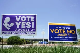 Signs for and against the Kansas Constitutional Amendment on abortion are displayed outside the Kansas 10 freeway in Lenexa, Kansas