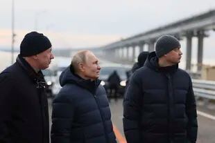 The Russian president, Vladimir Putin, in the center, and other Russian officials visit the bridge of Crimea that connects the continental part of Russia with the peninsula of Crimea on the Kerch Strait, which was recently repaired after the damage caused by a truck bomb attack. October, Monday, December 5, 2022. (Mikhail Metzel, Sputnik, Kremlin Pool Photo via AP)